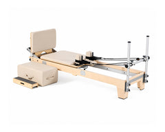 DZ1862 maple Pilates reformer with mounted jumpboard and cream upholstery, rear view